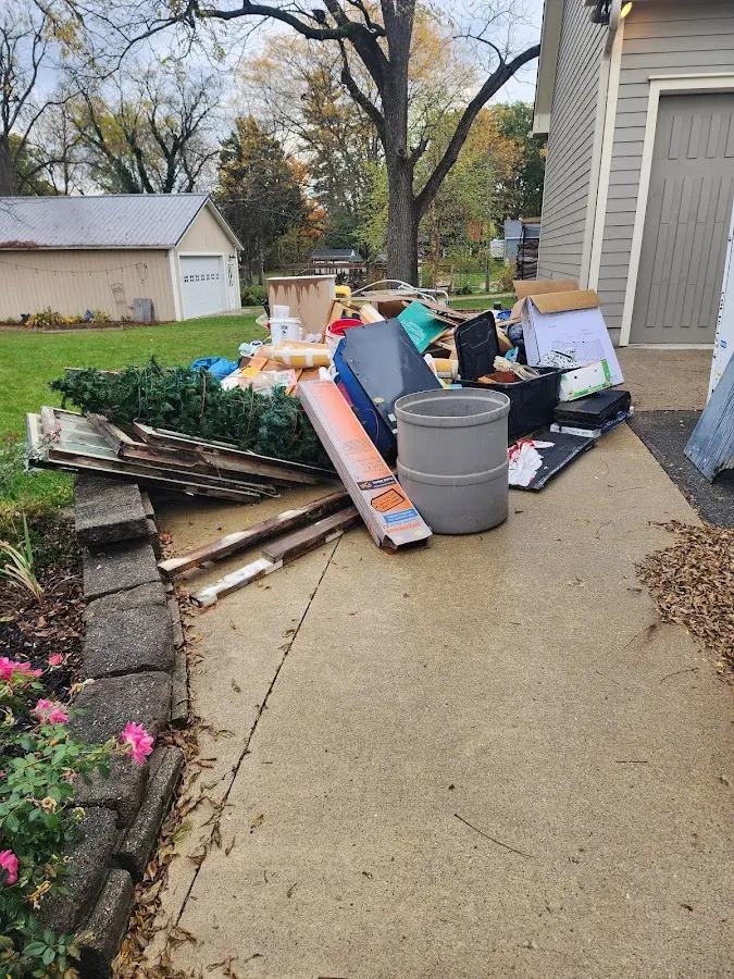Dumpster being loaded with debris for Residential Dumpster Rental in Menominee